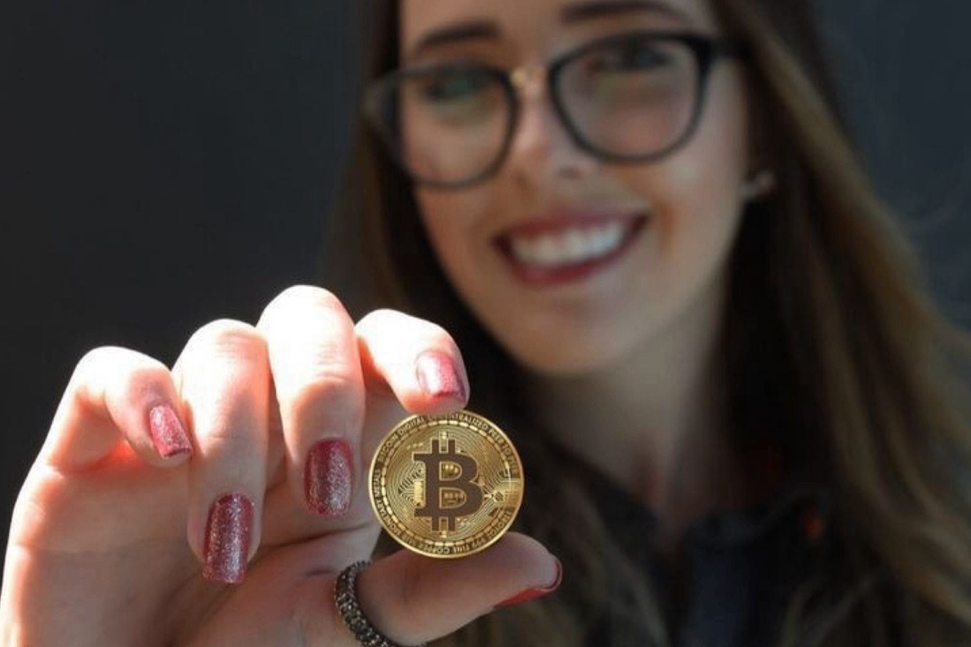 Investor holding a Bitcoin coin